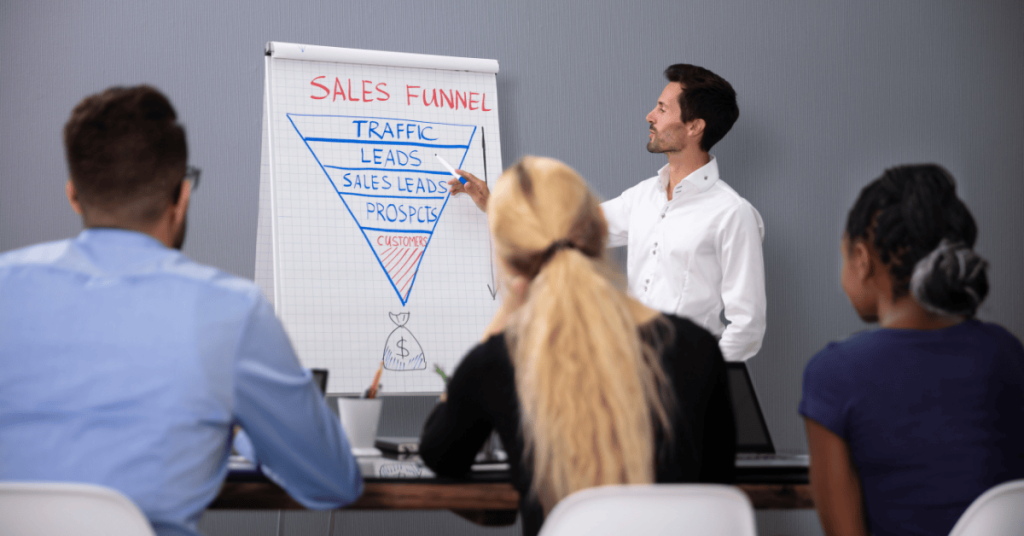 Man Giving Sales Funnel Presentation To His Colleagues