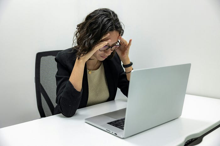 Overwhelmed Woman at Work Struggling with Workload and Stressed Out