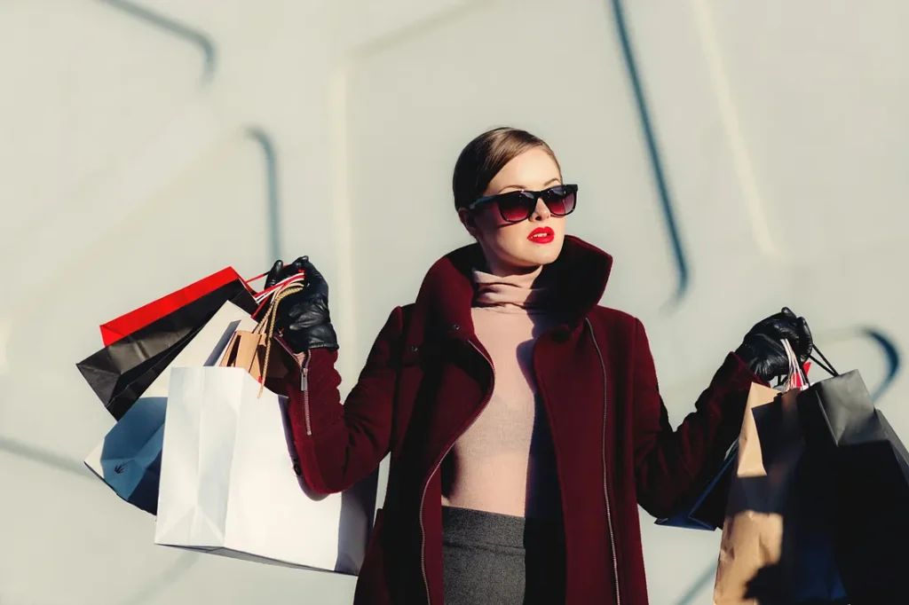 The Neuroscience of Persuasion: Lady holding multiple bags after a successful shopping trip.