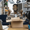 Afro man unboxing sneakers for creating video content