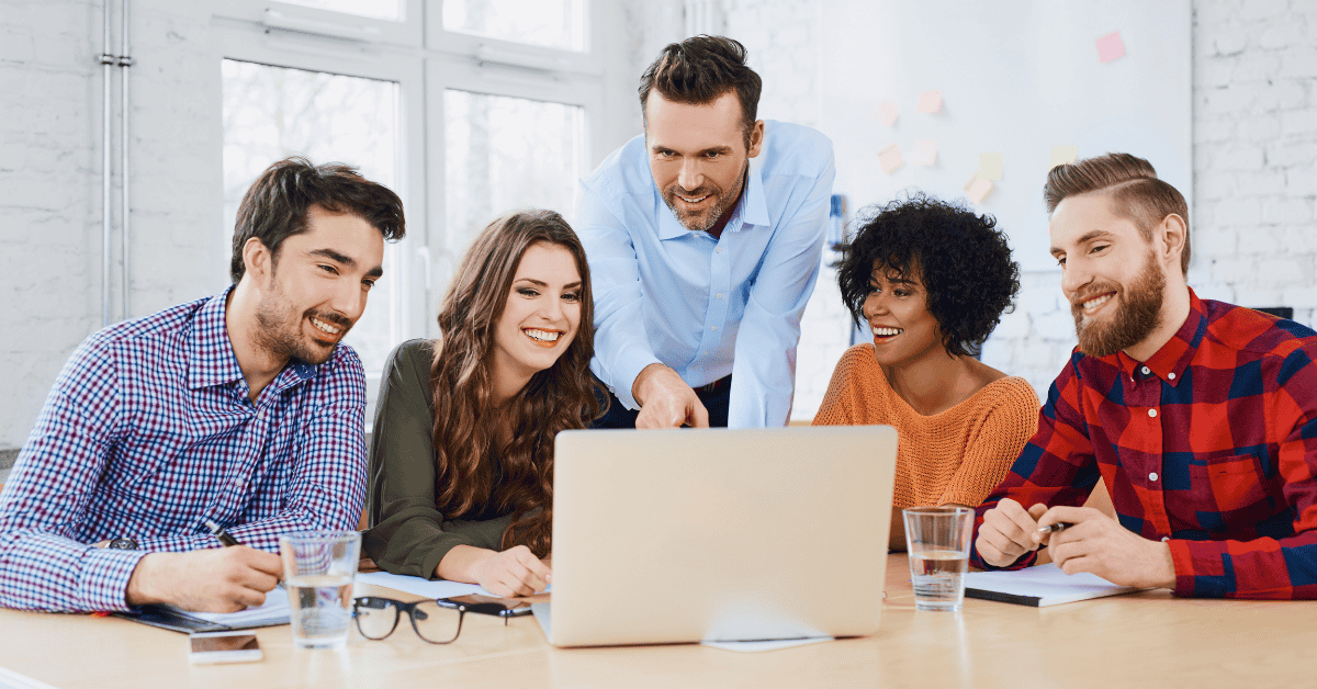 Creative agency coworkers discussing new project on laptop