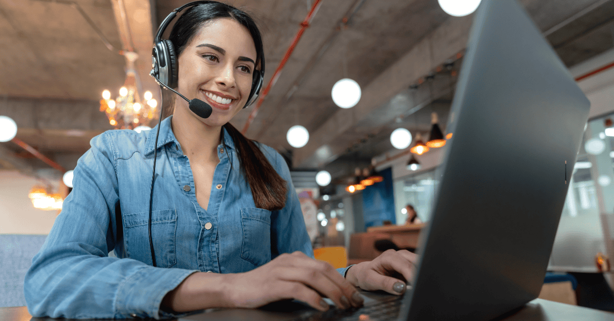 Virtual assistant services for digital marketing: Beautiful woman on a virtual meeting using her laptop and headset smiling