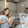 Woman Taking Online Order at Her Small Stall Shop