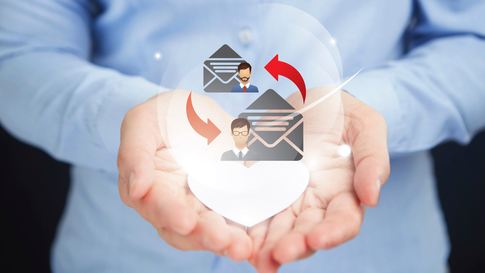 A person holding an email icon in their hands