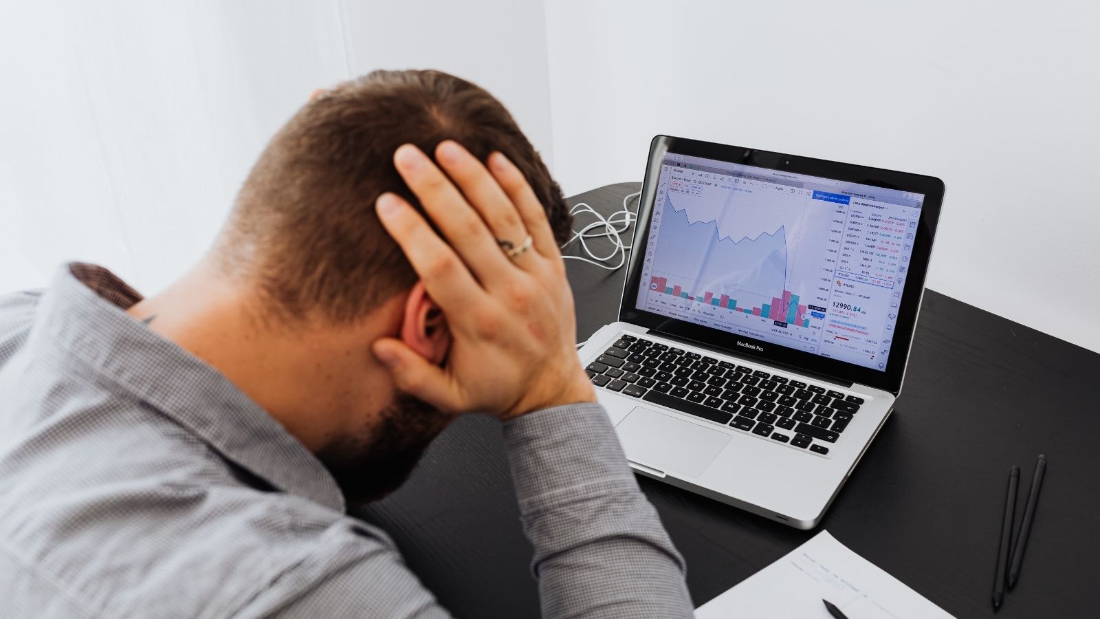 Frustrated marketer reviewing poor email open rates on screen with unopened emails in background